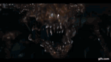 a close up of a monster in a room with a door in the background .