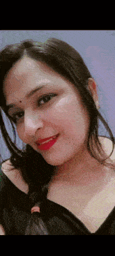 a close up of a woman 's face wearing red lipstick and a black shirt .