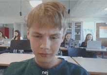 a boy in a green shirt with the word nej on his shirt