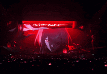 a woman with red eyes is being projected on a large screen in a dark room