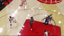 a basketball game is being played on a court with the word hawks on the floor