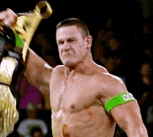 a shirtless wrestler with a green arm band that says nbp on it
