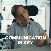 a man in a wheelchair with the words communication is key below him