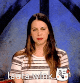 a woman wearing a striped shirt with the name laura wink written on it