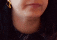 a close up of a woman 's face with a blurred background