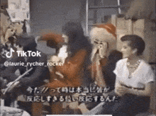 a group of people are sitting around a table with tiktok written on the bottom right corner