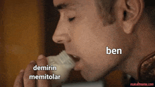 a close up of a man eating a piece of food with the words ben written above him