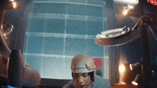 a person with a magnifying glass on their head looking at a screen with numbers on it