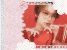 a picture of a girl wearing glasses holding a heart