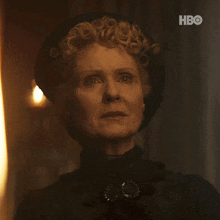 a close up of a woman 's face with the hbo logo on the bottom