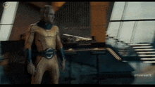 a man in a yellow and blue suit is standing in a room