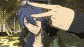 a man with long blue hair is making a peace sign with his hands .