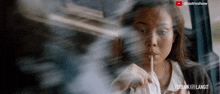 a woman is sitting in a car with a cigarette in her mouth and the words terbak ke langit on the bottom