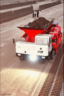 a white truck is driving down a dirt road with a brick wall in the background and the words imgflip.com at the bottom