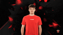 a young man wearing a red shirt that says tribe