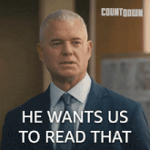 a man in a suit and tie with the words he wants us to read that behind him