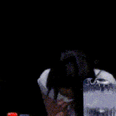 a woman is blowing her nose in front of a glass of water