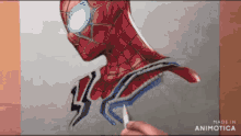 a person is drawing a picture of spider man