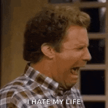 a man in a plaid shirt is screaming with his mouth open and says `` i hate my life '' .