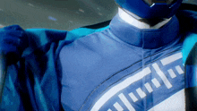 a close up of a person wearing a blue and white jacket