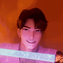 a man in a pink shirt is smiling and holding a glow in the dark item that says yy