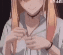 a close up of a girl with long hair holding her hair in her hands .