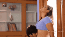 a man is kissing a woman 's stomach in front of a screen that says sf