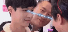 a group of young men are standing next to each other and one of them has a lightning bolt coming out of his nose .