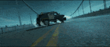 a black vehicle is driving on a bridge with smoke coming out of the tires