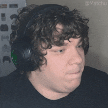 a man with curly hair wearing headphones with the hashtag @matchu on the bottom