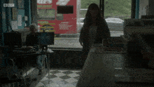 a woman stands in front of a computer screen that says movie pet on it