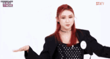 a woman with red hair is wearing a polka dot dress and a name tag that says statv .
