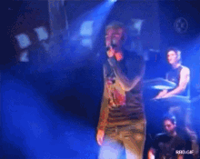 a man singing into a microphone with the words rbd.gif below