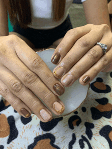 a close up of a woman 's nails with a ring