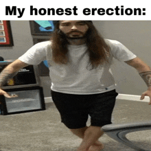 a man with long hair and a beard is standing in front of a mini fridge that says ' cooler box ' on it