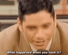 a man in a suit and tie is talking into a microphone .