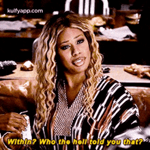 a woman is sitting on a couch holding a can of soda and asking who the hell told you that .