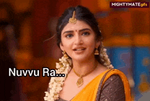 a woman in a yellow and brown dress with flowers in her hair says nuvvu ra ...