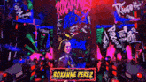 roxanne perez is standing in front of a glow in the dark sign