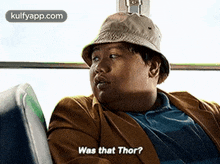 a man wearing a hat is sitting on a bus and says `` was that thor ? ''