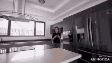 a woman is standing in a kitchen with the words made in animotica above her