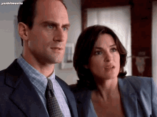 a man in a suit and tie stands next to a woman in a blue shirt with yazbitmesilin written below them
