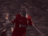 a soccer player wearing a red shirt with the number 10 on it