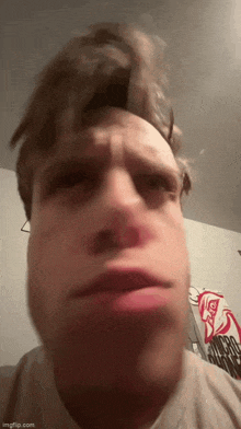 a close up of a man making a funny face with his mouth open .