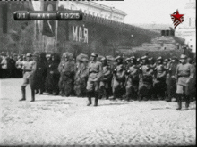 a black and white photo of soldiers marching with the date 1911