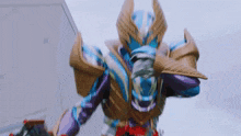 a blue and purple robot with wings is standing in front of a building and holding a sword .