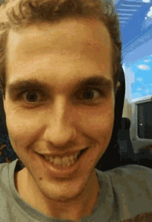 a man is smiling and looking at the camera