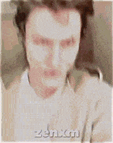 a blurry picture of a man with zenxn written on the bottom right