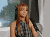 a woman wearing headphones with the letter b on it
