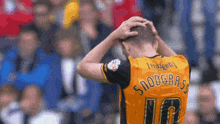 a soccer player with the name snoograss on the back of his jersey